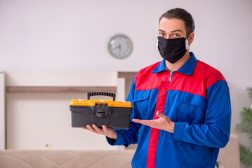 Young carpenter working indoors during pandemic disease