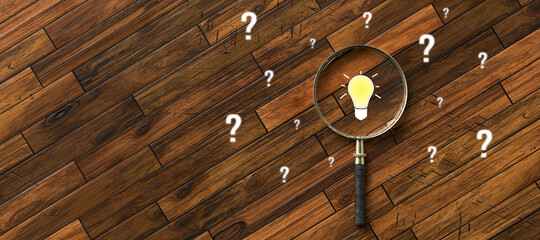 magnifying glass with lightbulb as symbol for finding a solution on wooden background