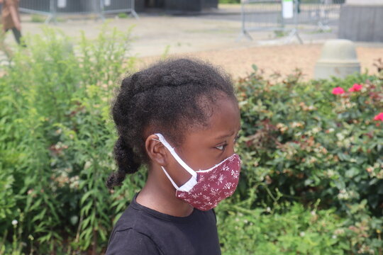 Child Wearing Cloth Face Mask Side Profile Standing Outdoors