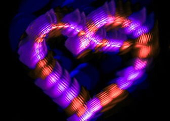 Light painting heart shape over black background