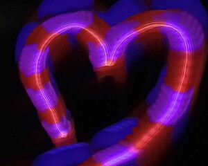 Light painting heart shape over black background