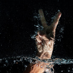 Water splash in hands with peace symbol
