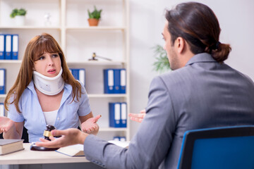 Young injured woman and male lawyer in the courtroom