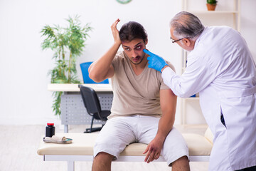 Young face injured man visiting experienced male doctor traumato