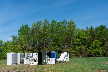 Naklejka premium Pile of defunct refrigerators at landfill