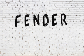 Inscription fender painted on white brick wall