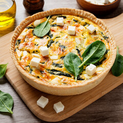 Vegetarian spinach pie or quiche with feta cheese .