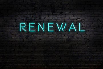 Night view of neon sign on brick wall with inscription renewal
