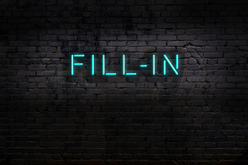 Neon sign. Word fill-in against brick wall. Night view