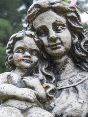 Closeup of weathered grave statue of the Madonna and baby  Jesus