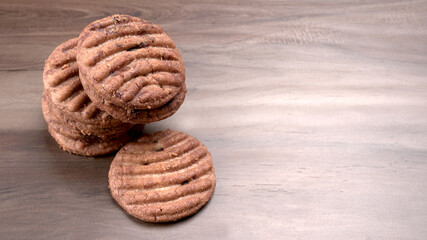 Homemade oatmeal cookies with flax and sesame seeds on white wooden table, copy space. Healthy vegan oat cookies