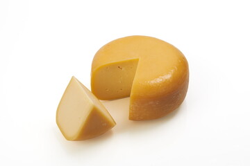 whole round and one peace of organic produced cheese