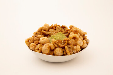 pork rind in bowl and with guacamole in white background