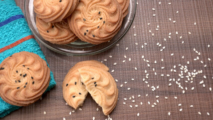 Homemade oatmeal cookies with flax and sesame seeds on white wooden table, copy space. Healthy vegan oat cookies