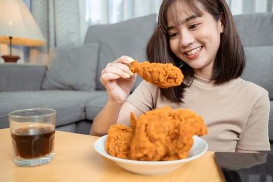 Young Asian Woman Takeaway Eating Junk Food Chicken Nuggets Wing.