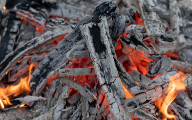 Red hot burning coals, remains of campfire.