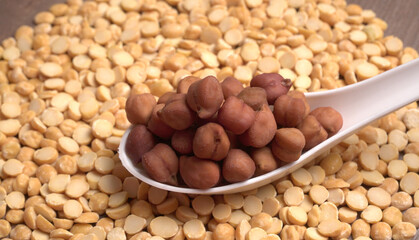 Black Chickpeas or Kala Chana with chana dal pulse isolated on wooden Background.