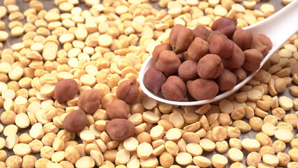 Black Chickpeas or Kala Chana with chana dal pulse isolated on wooden Background.