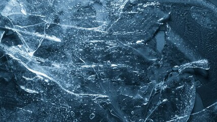 Close-up of melting ice texture. Studio shot close-up of the blue surface of cracked melting ice in time lapse. - Powered by Adobe
