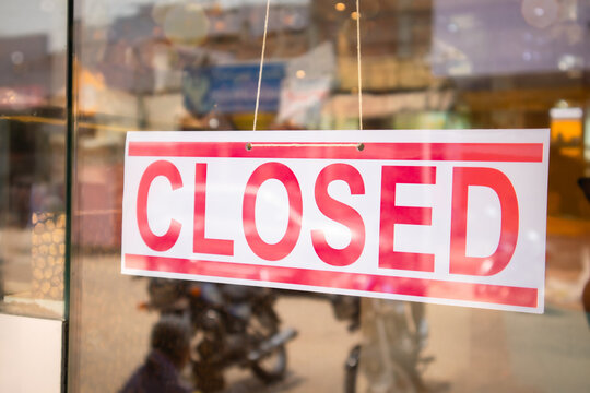 Closed Signage board in front of Businesses or store door due covid-19 or coronavirus outbreak - Concept of business closed due lockdown.
