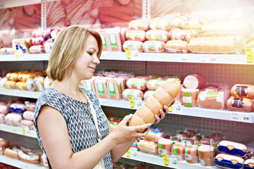Woman buying sausages in shop