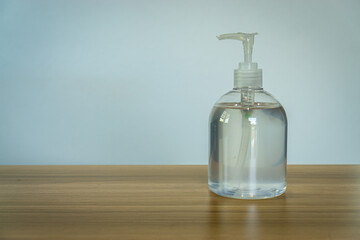 close up of Clear hand sanitizer in a clear pump bottle on wooden table background, Corona virus hands hygiene