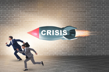 Concept of crisis with businessman chased by rocket