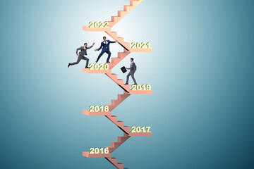 Businessman climbing stairs on yearly basis