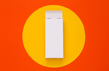 Open White packing box on orange background with yellow circle. Minimalism. Top view