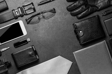 Men's accessories on a black concrete background. The concept of a successful modern man. Copy space