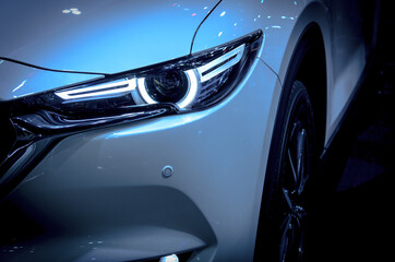 Headlights of white car.