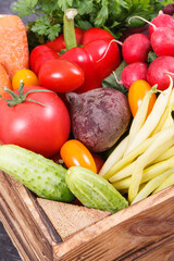 Fresh ripe vegetables in wooden box as healthy snack containing vitamins