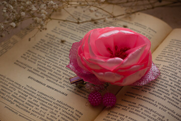 Handmade hair pins on an old vintage book with dried flowers