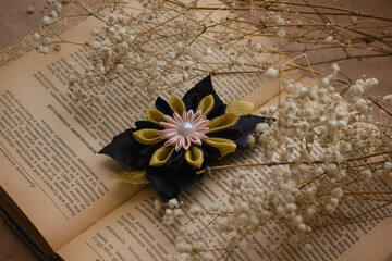 Handmade hair pins on an old vintage book with dried flowers