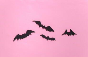 Halloween background, decorations and scary concept. Black bats fly over pink bright background, Copy space