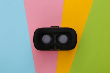VR headset on colored background. Virtual reality. Flat lay. Top view