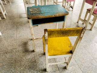 Blue and yellow old student desk
