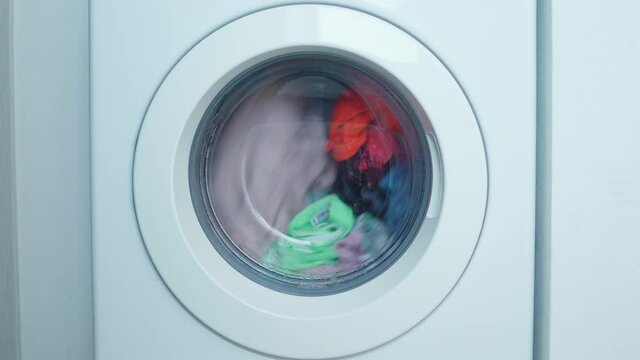 Spinning drum of a washing machine with casual clothes. Laundry day