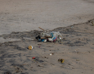 Obraz premium Waste accumulated on the shores of a sea. Pile of waste that washed ashore on a beach.