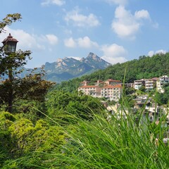 Fototapeta na wymiar Luxury home complex surrounded by mountains in asia, summer day