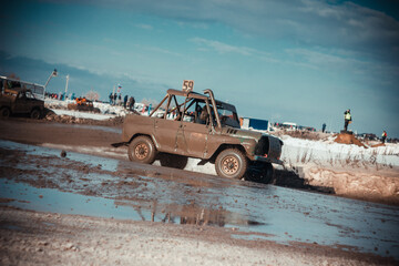 Dirty race cars ride off-road at competitions