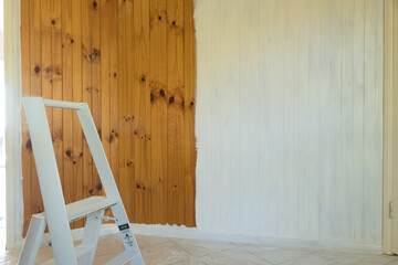 Timber wall being painted, half done