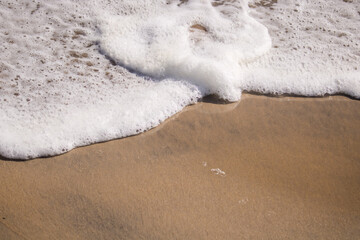 White sea foam in a beach.