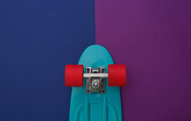 Cruiser board on a classic blue purple background. Youth entertainment. Top view.