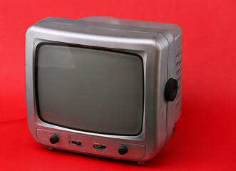 Old tv receiver on red background.