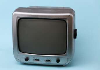 Old tv receiver on blue background.