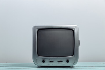 Old tv receiver on white wall background. Retro media