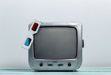 Retro tv receiver with anaglyph 3d glasses on white wall background