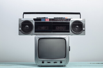 Retro tv receiver with audio tape recorder on a white wall background. Retro media
