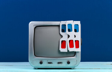 Retro tv receiver with anaglyph 3d glasses on classic blue background